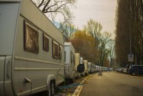 Camping Trailers Parked In A Row Along A Street With Electrical Lines And Hoses For Hook Up; Locarno, Ticino, Switzerland — Stock Photo