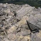 Pico rocoso de montaña con valle y árboles a pie - foto de stock