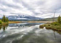Lake reflections and the Rocky Mountains near Jasper in the early morning, Jasper National Park; Alberta, Canada — Stock Photo