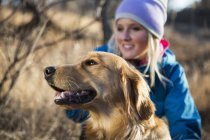 A golden retriever with it's female owner; Anchorage, Alaska, United States of America — Stock Photo