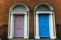Georgian architecture and painted house doors with red brick facade in Dublin city centre; Dublin, Leinster, Ireland — Stock Photo