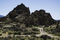 Family walking down a road in the Alabama Hills, California, USA — Stock Photo