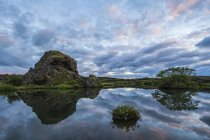 Sunset over the old lava and small pond near Lake Myvatn, North Iceland; Iceland — Stock Photo