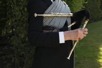 Cropped image of musician with northumbrian smallpipes — Stock Photo