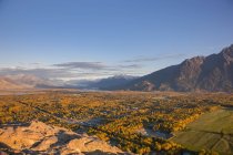 View of Palmer and Knik River from atop the Butte, the Chugach Mountains in the background on a clear, sunny evening, South-central Alaska; Palmer, Alaska, United States of America — Stock Photo