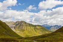 Mountains covered in green tundra on a sunny day in Hatcher Pass, South-central Alaska; Palmer, Alaska, United States of America — Stock Photo