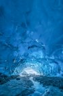 A stream flows beneath an ice cave on Mendenhall Glacier, Tongass National Forest; Alaska, United States of America — Stock Photo