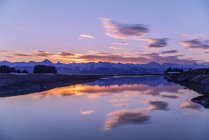 Eagle River and Eagle Beach during a brilliant colored sunset and Chilkat Mountains; Juneau, Alaska, United States of America — Stock Photo