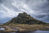 Moody e scena drammatica di una piccola collina lungo la riva meridionale dell'Islanda; Islanda — Foto stock