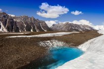 Glacial lake on Kennicott Glacier, with Wrangell Mountains in background, Wrangell, St. Elias National Park and Preserve; Alaska, United States of America — Stock Photo