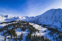 Landscape of clouds forming over Kickstep and Tincan Peaks in the backcountry of Turnagain Pass in South-central Alaska on a sunny winter day, Seward, Alaska, United States of America — Stock Photo