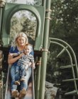 Mother on a slide with young son; Edmonton, Alberta, Canada — Stock Photo