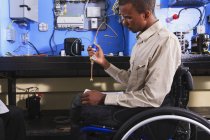 Студент в інвалідному візку вивчає кондиціонер високого тиску в класі HVAC — стокове фото