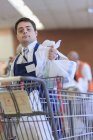 Man with Down Syndrome working at a grocery store — Stock Photo