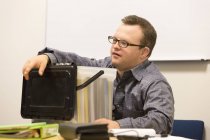 Portrait of hospital aid worker with Down Syndrome working in office — Stock Photo