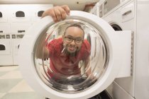 African American man with Down Syndrome for laundry in utility room — Stock Photo