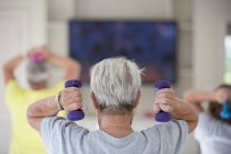Rear view of senior woman in gym — Stock Photo