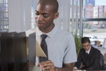 African American man with Autism working in office — Stock Photo