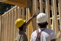 Carpenters planning at a building construction site — Stock Photo