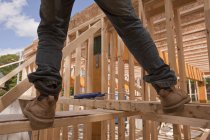 Carpenter balancing on upper floor at a building construction site — Stock Photo
