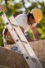 Carpenter working at a building construction site — Stock Photo