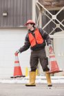 Transportation engineer moving traffic cones at a construction site — Stock Photo