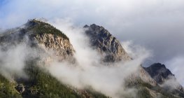 Clouds gather around Rocky mountain peaks; Field, British Columbia, Canada — Stock Photo