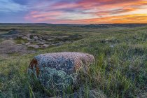 Vast landscape stretching to the horizon at sunset in Grasslands National Park; Val Marie, Saskatchewan, Canada — Stock Photo