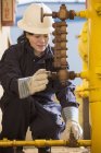 Female power engineer checking fuel line sensors at power plant — Stock Photo