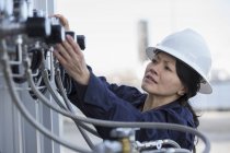 Female power engineer checking transducer at power station — Stock Photo