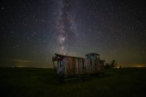 Old caboose at nighttime under a bright, starry sky; Coderre, Saskatchewan, Canada — Stock Photo