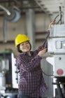 Female power engineer securing cable to equipment truck — Stock Photo