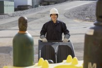 Female power engineer using compressed gas cart at power plant — Stock Photo
