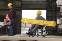 Maintenance supervisors one with spinal cord injury preparing to load shielding onto utility truck — Stock Photo