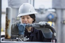 Female power engineer checking transducer at power station — Stock Photo
