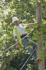Lineman on a pole working on phone and cable wires — Stock Photo