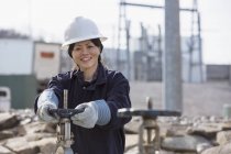 Female power engineer adjusting water valves at power plant — Stock Photo