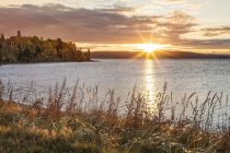 Tranquil Lake Superior and autumn colours at sunset; Ontario, Canada — Stock Photo