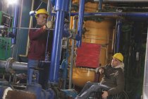 Power plant engineers one with spinal cord injury inspecting demineralization pipes — Stock Photo