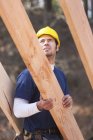 Carpenter placing a rafter for house construction — Stock Photo