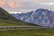 Il Trans-Alaska Pipeline si estende attraverso la tundra sotto le montagne scoscese del Brooks Range; Alaska, Stati Uniti d'America — Foto stock