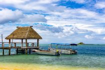 Pier and boats moored off an island in the South Pacific; Malolo Island, Fiji — Stock Photo