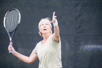 Старша жінка грає в теніс — стокове фото
