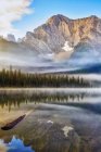 Tranquil lake with reflections in Elk Lakes Provincial Park; British Columbia, Canada — Stockfoto