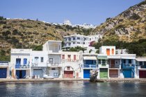 Klima village with white houses and colourful accents along the water edge; Klima, Milos Island, Cyclades, Greece — Stock Photo