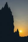Sunset at Prambanan Temple with silhouetted peaks; Yogyakarta, Indonesia — Stock Photo