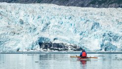 Kayaker in front of a tidewater glacier in Prince William Sound; Alaska, United States of America — Stock Photo