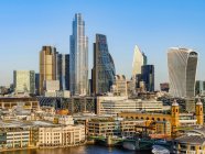 Cityscape and skyline of London with 20 Fenchurch, 22 Bishopsgate, and various other skyscrapers, and the River Thames on the foreground; London, England — стокове фото