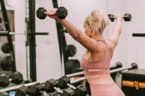 Woman working out with weights; Wellington, New Zealand — Stock Photo