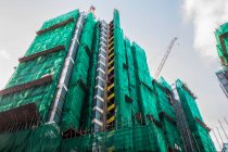 High-rise apartment building under construction; Hong Kong, China — Stock Photo